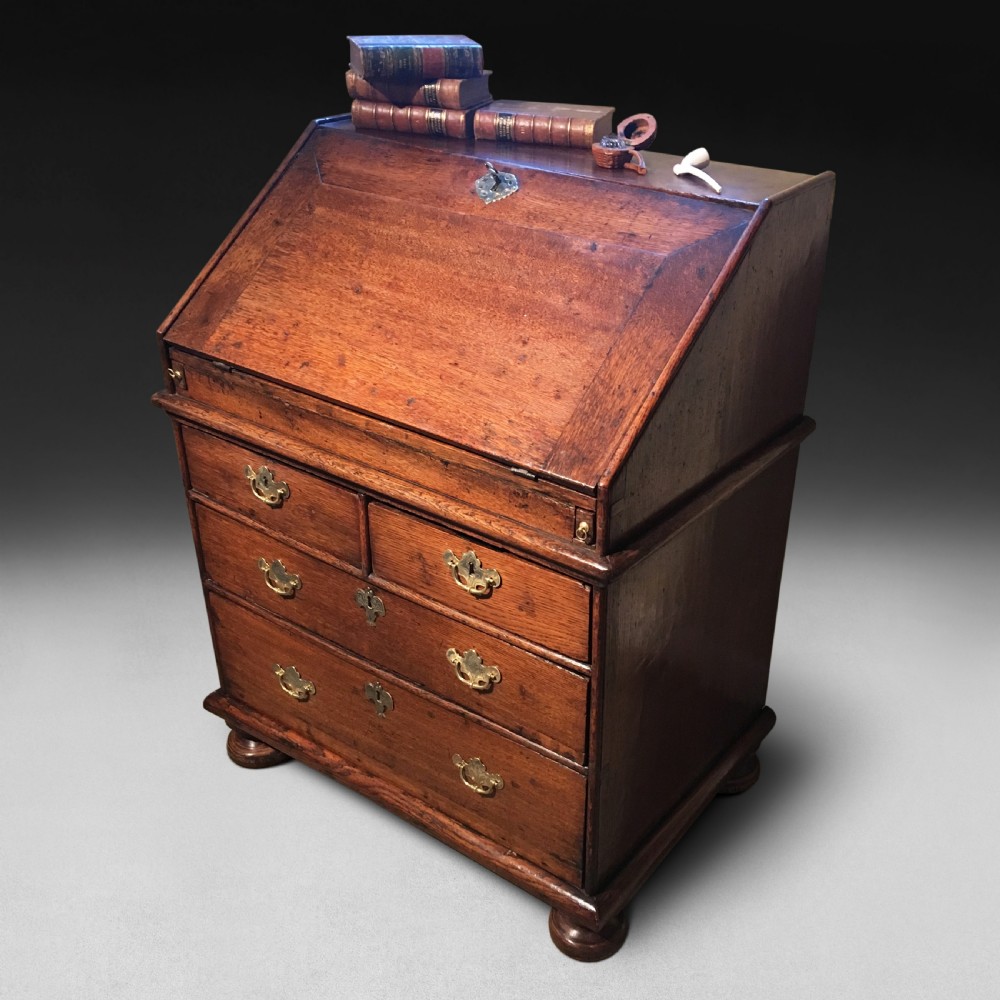 A charming and small Queen Anne Period Oak Bureau