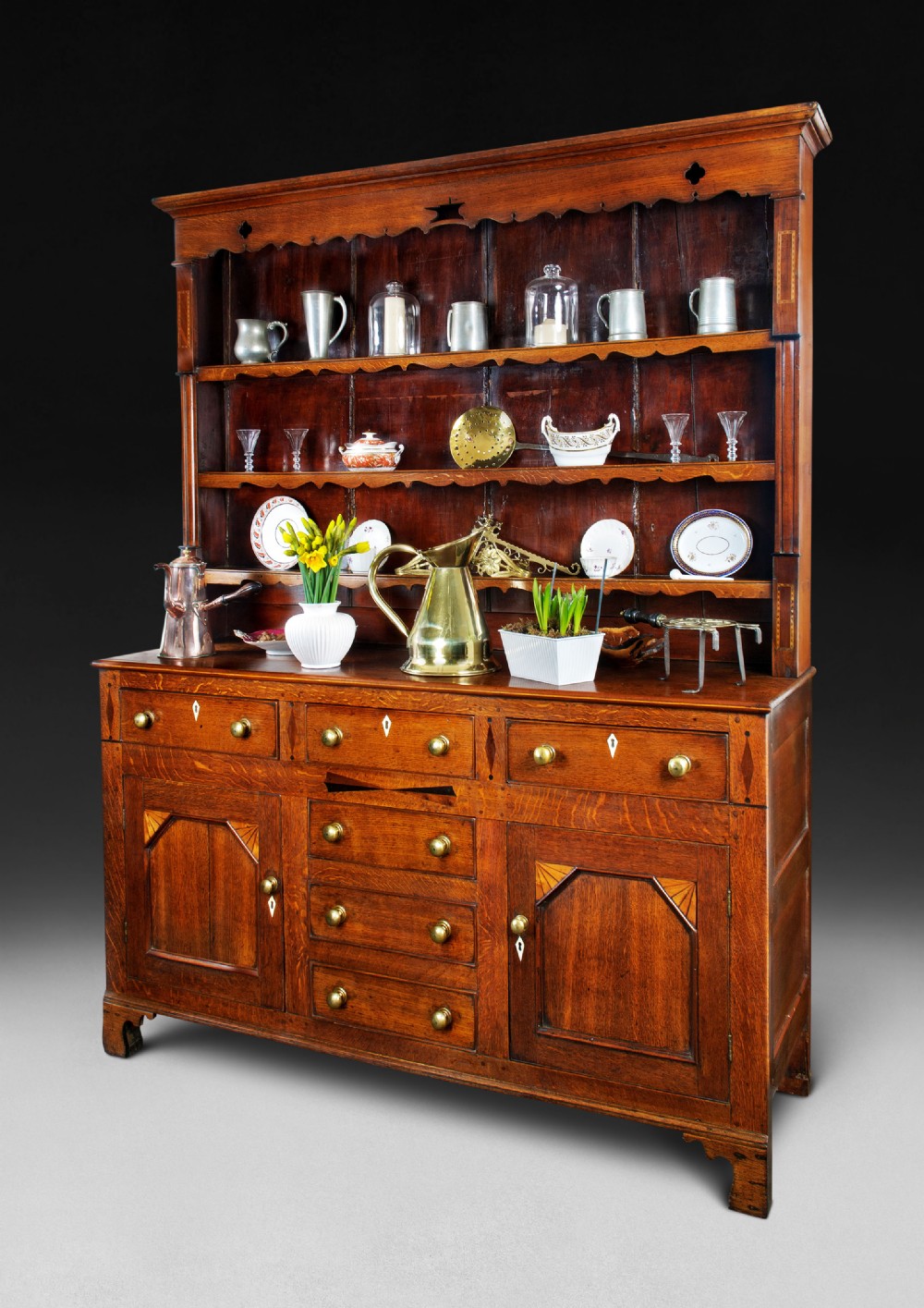 An early 19th. Century Oak and Inlaid Dresser and Rack