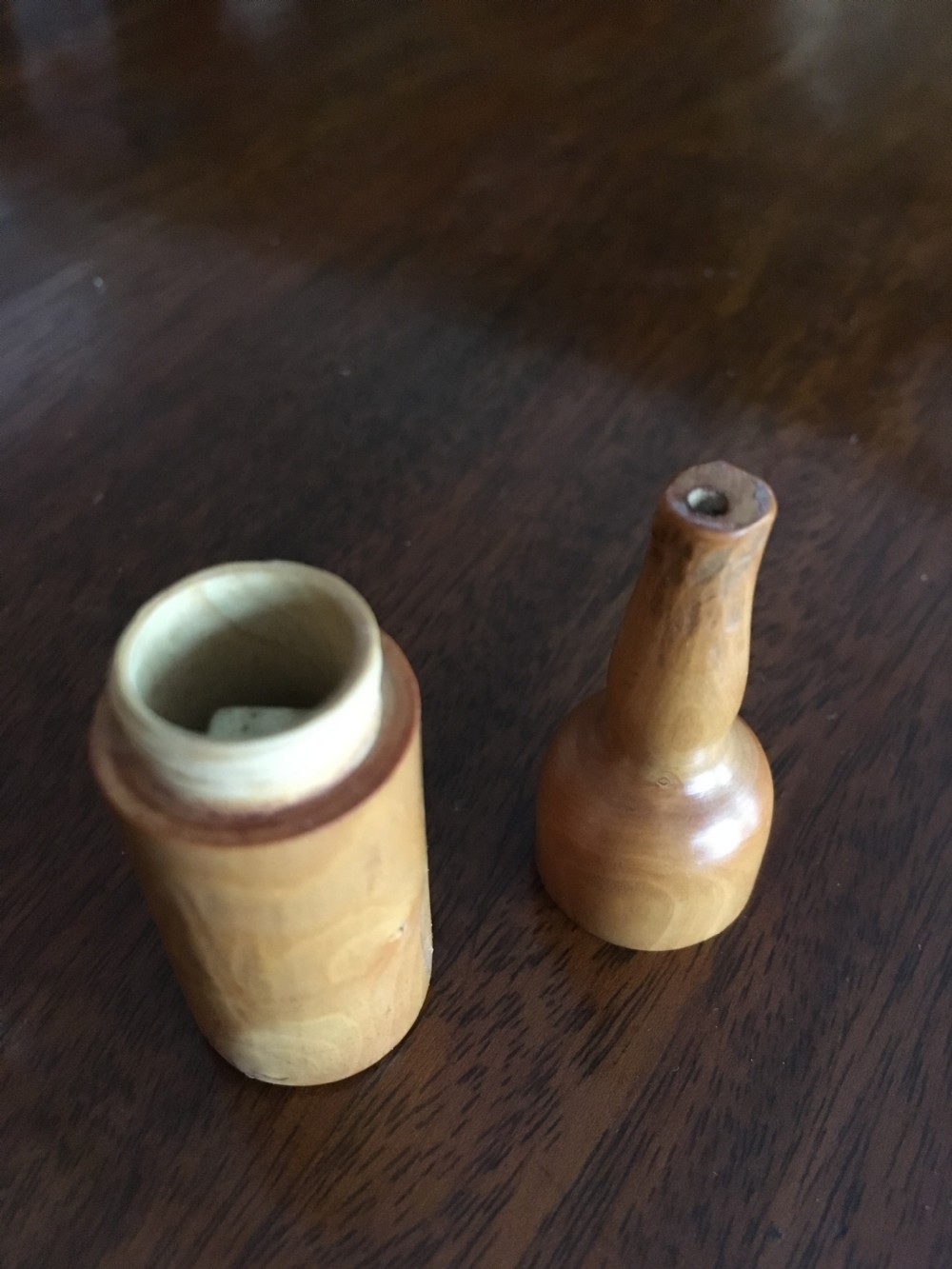 Miniature wooden bottle shaped box containing three small bone dice. View IV