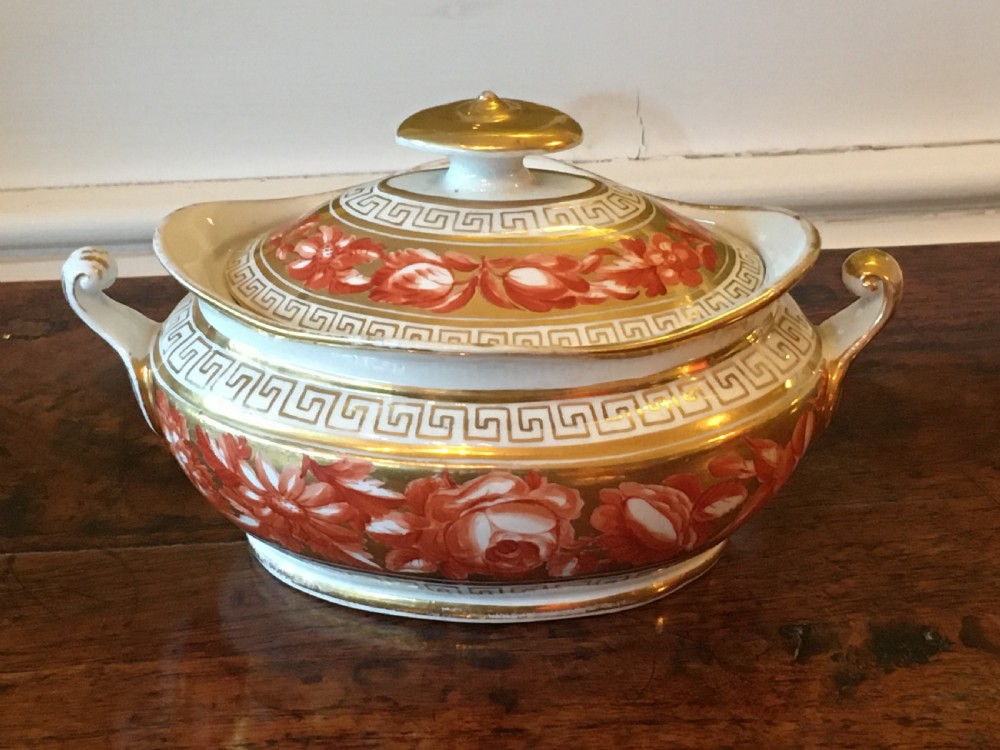 A Regency Coalport porcelain covered sucriere decorated with orange hand-painted flowers, gilded Greek key borders, and twin side handles.