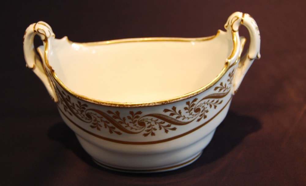 A white boat-shaped antique porcelain sucriere featuring gold leaf foliate scrollwork and twin curved handles. View IV