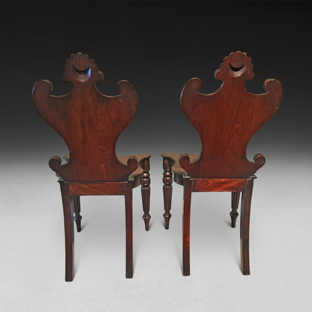 A pair of Regency mahogany hall chairs View II