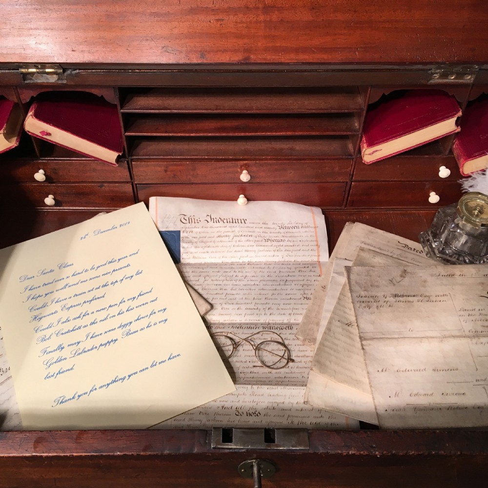 A George III mahogany tally desk featuring a slanted writing surface, a single drawer with a brass keyhole, and four tapered square legs. View III