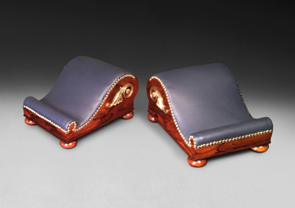 Pair of Regency Rosewood and Brass Gout Stools of scrolling form with leather upholstered foot rests View II