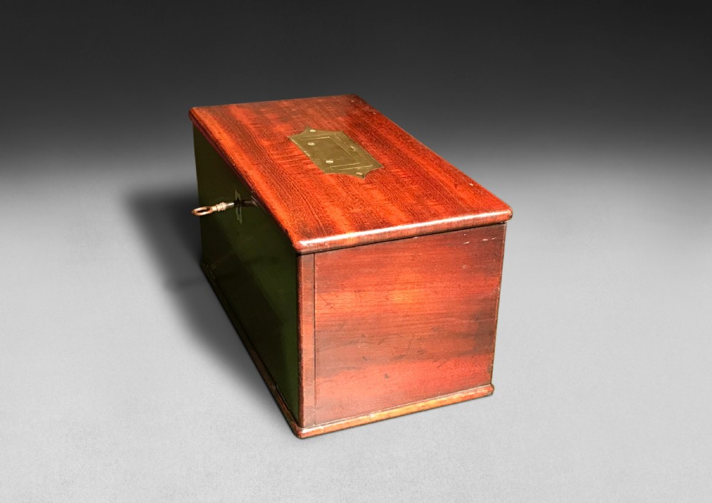 A Regency mahogany apothecary box shown open to display glass bottles, small drawers, brass fittings, and a key. View VI