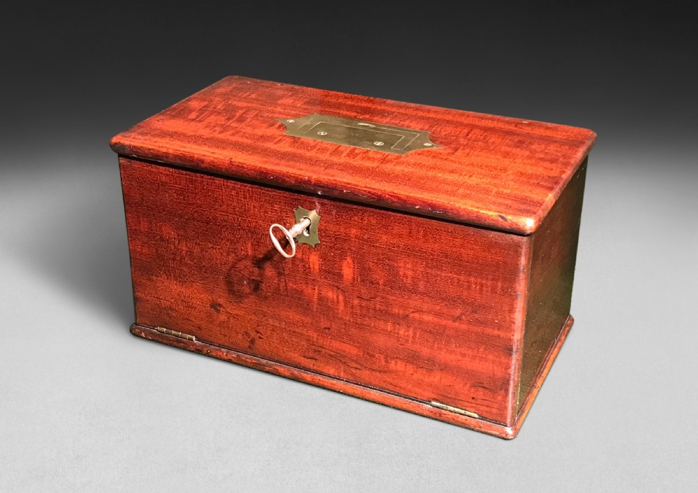 A Regency mahogany apothecary box shown open to display glass bottles, small drawers, brass fittings, and a key. View VII