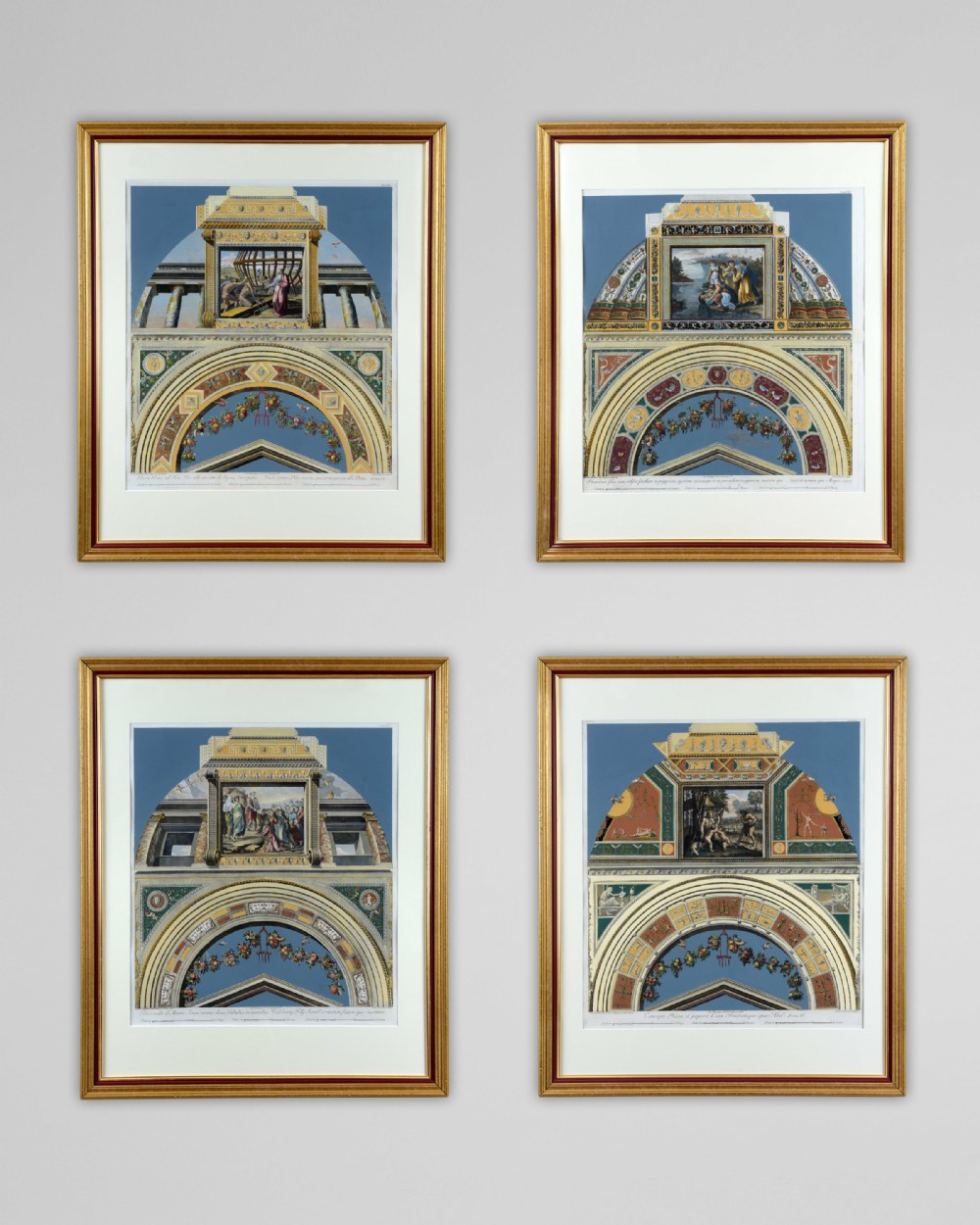 A set of four gilt-framed 18th-century hand-coloured architectural engravings depicting classical arches and frescoes from Raphaels Vatican Loggia on blue background.