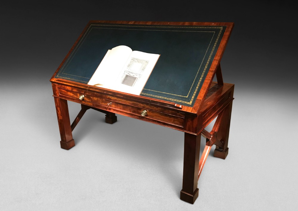 A Regency mahogany library table with a leather writing surface, a low rear gallery, a frieze drawer with brass knobs, and structured end supports. View III