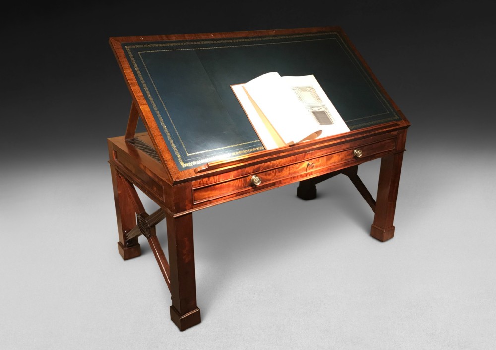 A Regency mahogany library table with a leather writing surface, a low rear gallery, a frieze drawer with brass knobs, and structured end supports. View IV