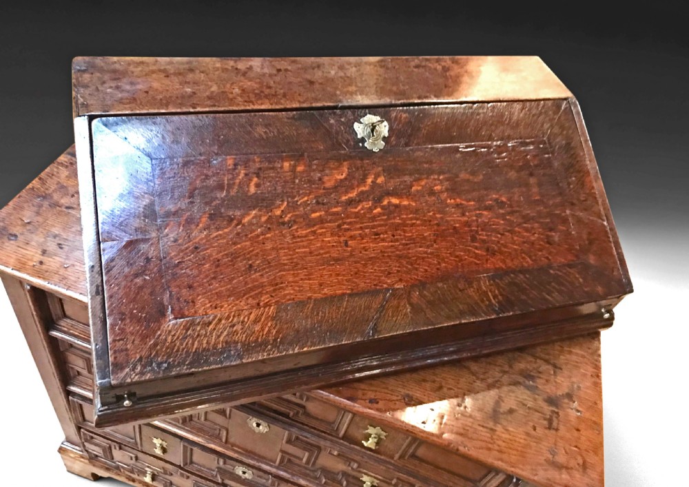 An antique dark oak table top bureau shown open, featuring a fall-front writing surface, internal pigeonholes, and small tiered drawers. View II
