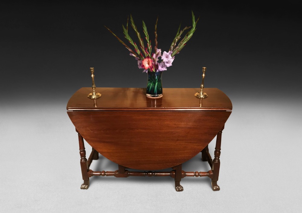 A mahogany Queen Anne gateleg table featuring two drop leaves, turned legs, pad feet, and a central end drawer. View III