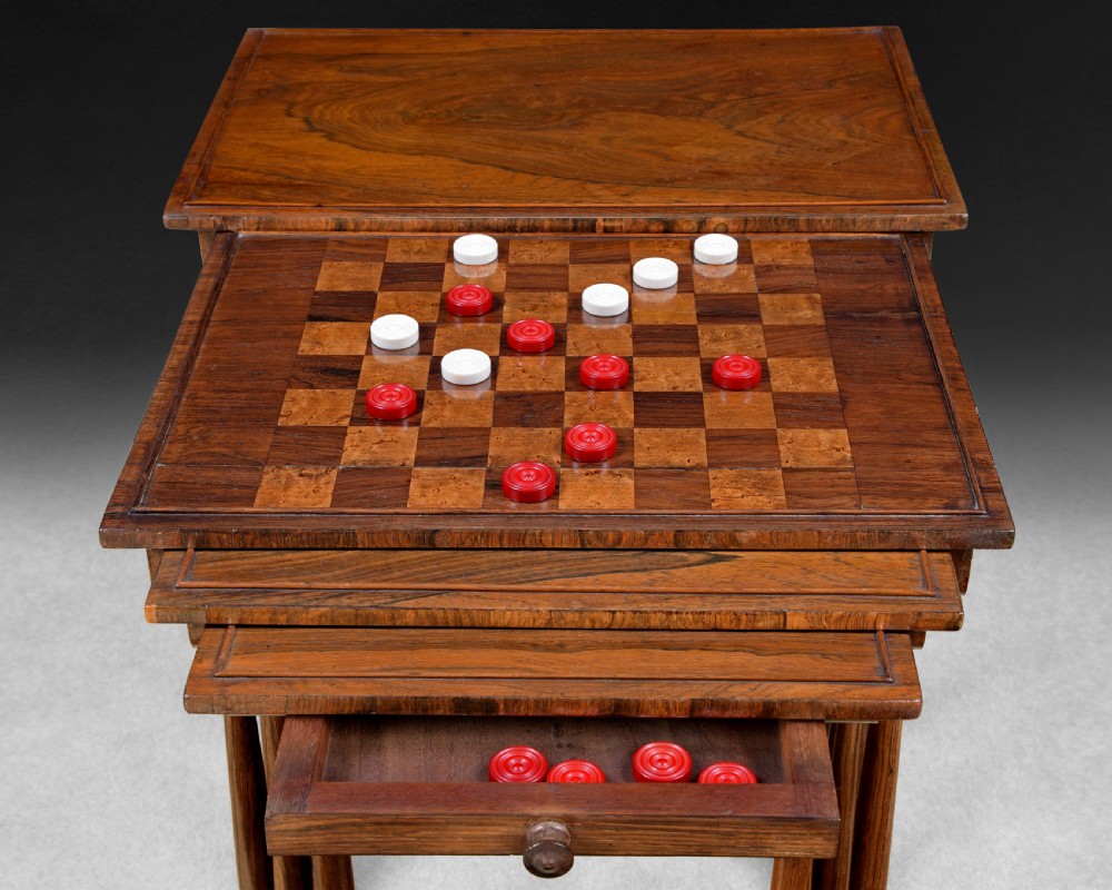 A set of four nested Regency rosewood quartetto tables featuring turned spindle legs, twin-ring stretchers, and an inlaid chessboard on the second surface. View III