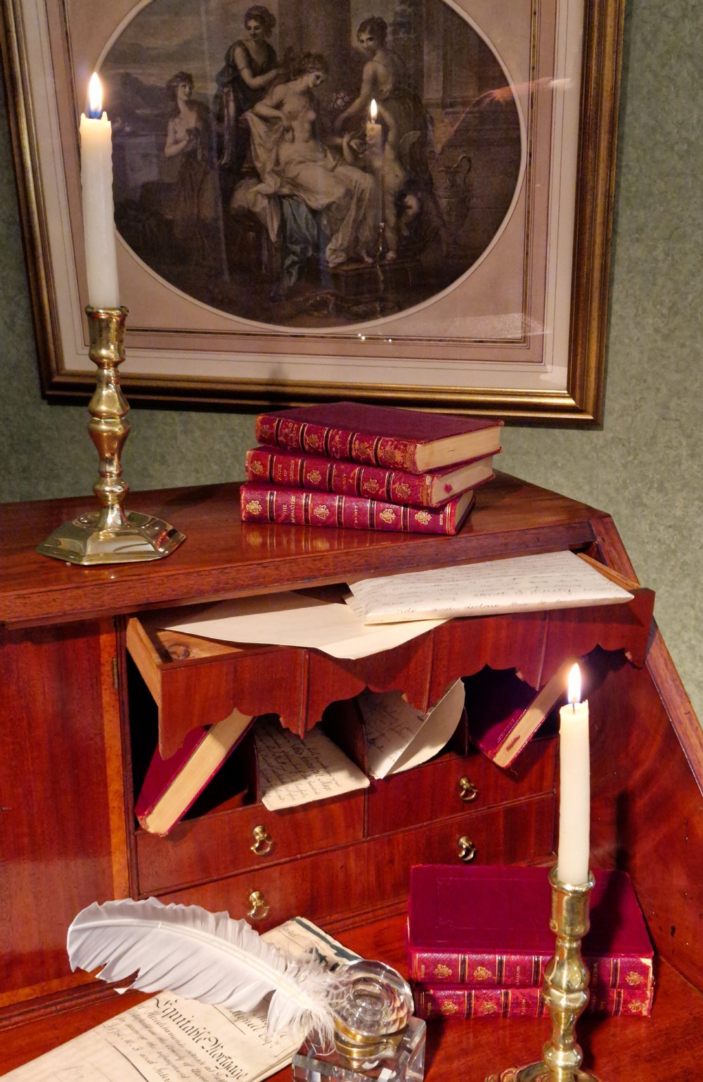 A George III flame mahogany slant-front writing bureau featuring burr yewwood crossbanded borders, four graduated drawers with brass handles, and bracket feet. View III