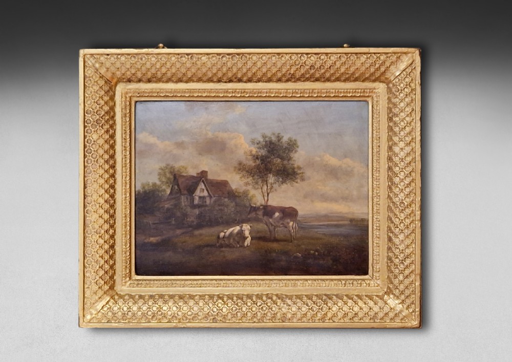 A pair of early 19th-century pastoral oil paintings depicting rural landscapes with grazing cattle, housed within matching decorative gilded frames. View II
