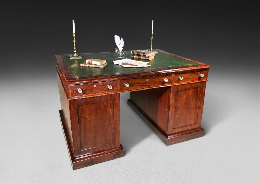 An early nineteenth-century mahogany twin-pedestal partners desk featuring a green leather inset writing surface and multiple drawers. View III
