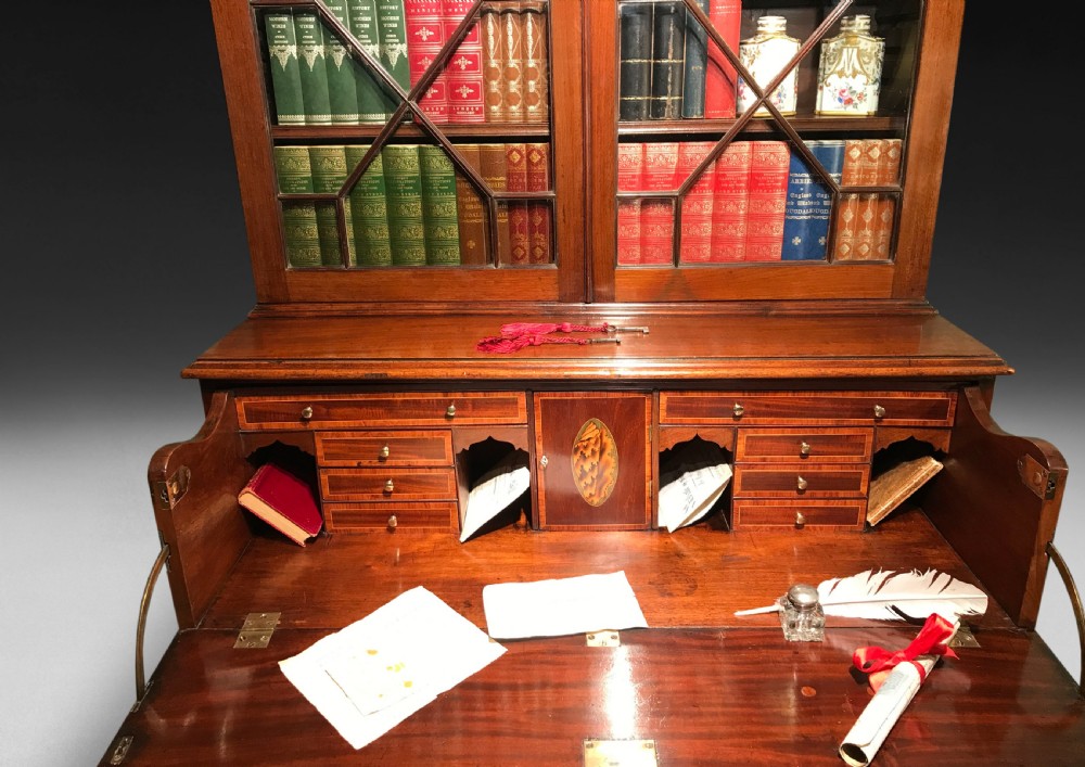 A George III mahogany secretaire bookcase featuring upper glazed doors with geometric astragal bars and an open drop-front writing compartment above lower drawers. View III