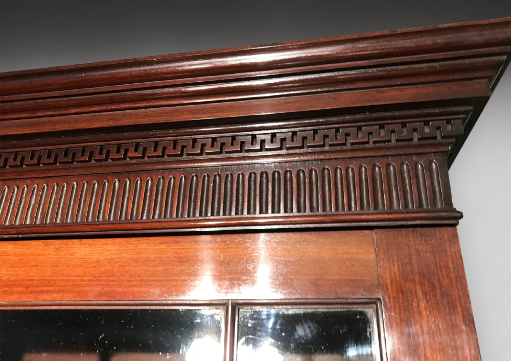 A George III mahogany secretaire bookcase featuring upper glazed doors with geometric astragal bars and an open drop-front writing compartment above lower drawers. View VI