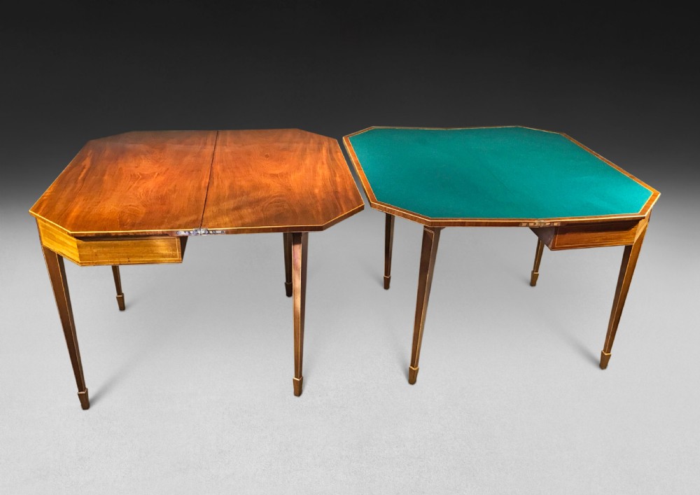 A pair of George III mahogany fold-over card tables with linear stringing inlay and square tapered legs. View II