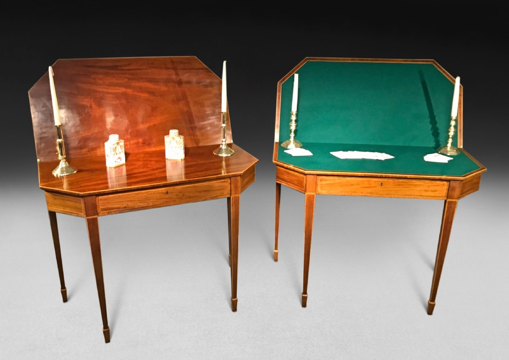 A pair of George III mahogany fold-over card tables with linear stringing inlay and square tapered legs. View VII