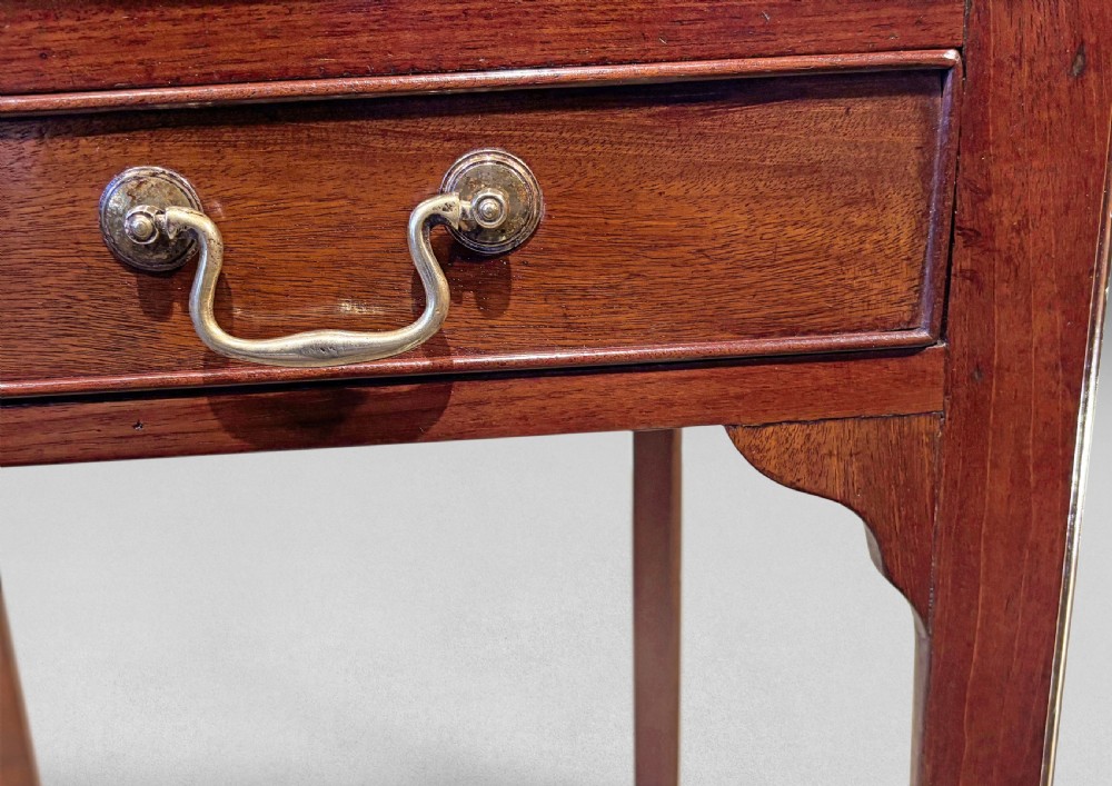 A mid-18th-century dark mahogany writing table featuring a long front drawer with brass handles and extended side slides. View III