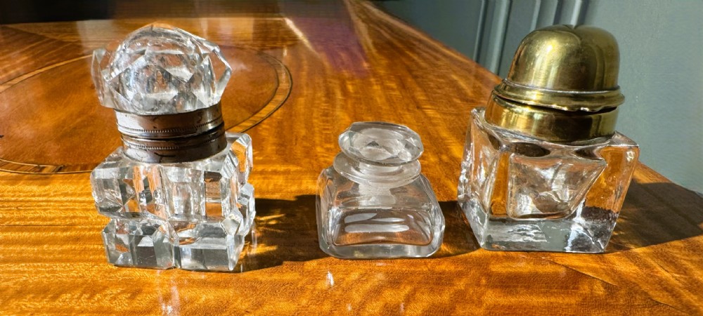 a trio of glass inkwells