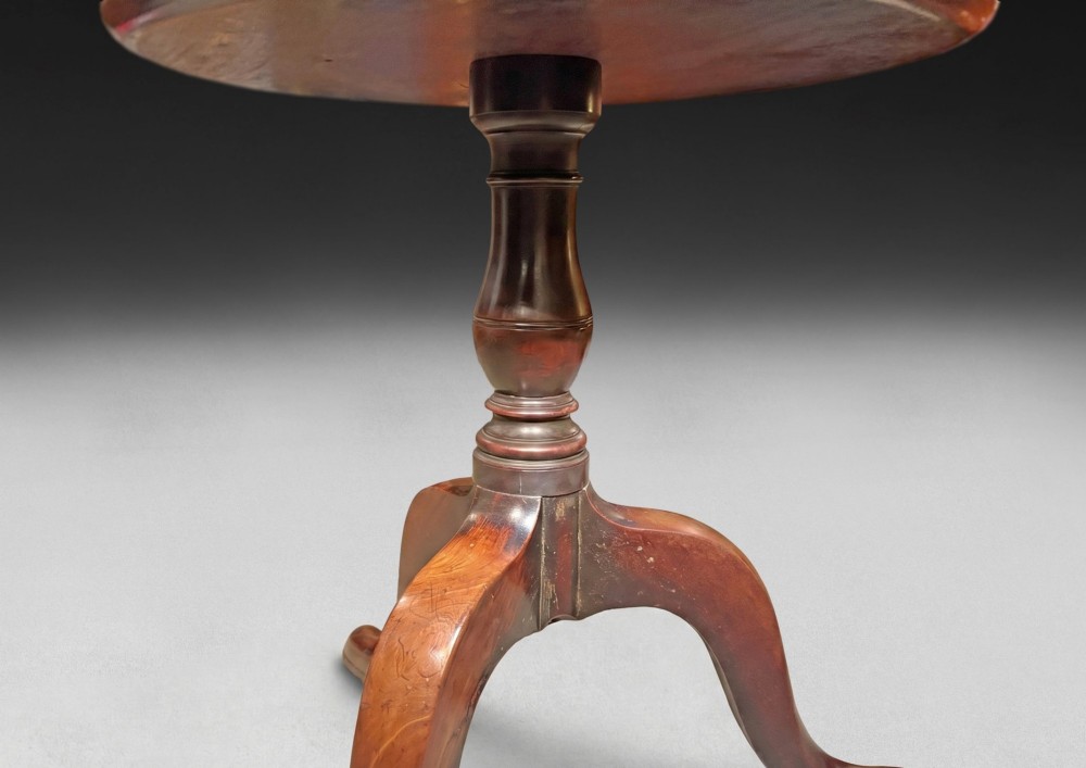 A George III mahogany three-tier dumb waiter featuring graduated circular trays on a turned central column supported by a tripod base. View VI