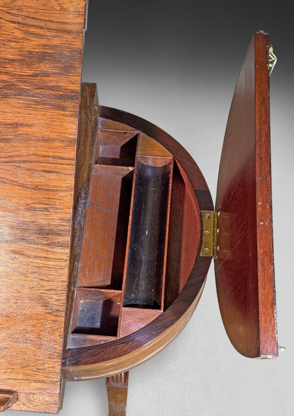 A Regency rosewood compendium table with brass stringing inlay, a single drawer, a pleated yellow silk basket underneath, and splayed legs ending in brass castors. View IV