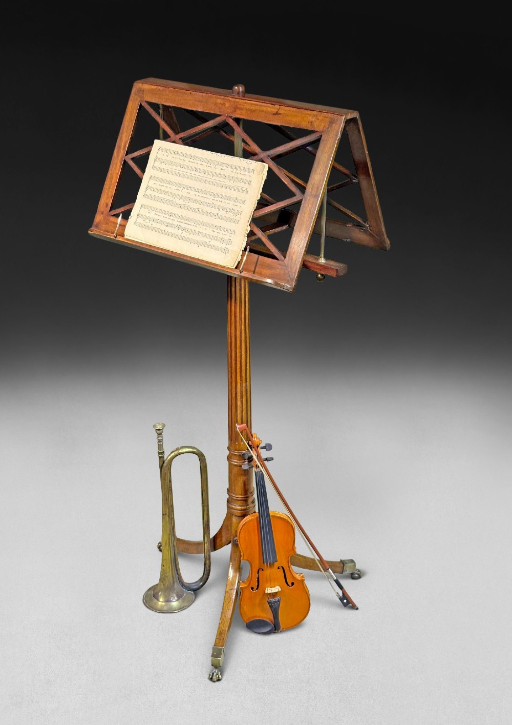 A Regency mahogany duet music stand with a double-sided lattice desk, adjustable brass stem, reeded column, and tripod base. View II