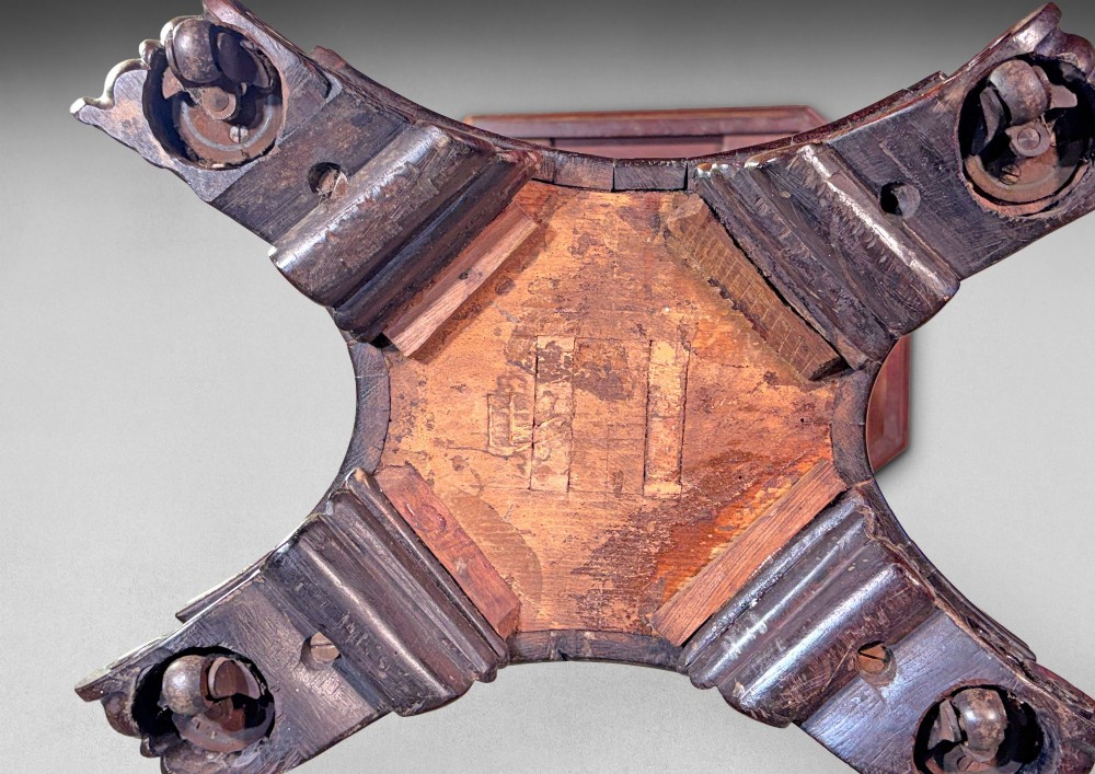 An antique Regency rosewood octagonal wine table with a faceted central column and a carved quadform base. View IV