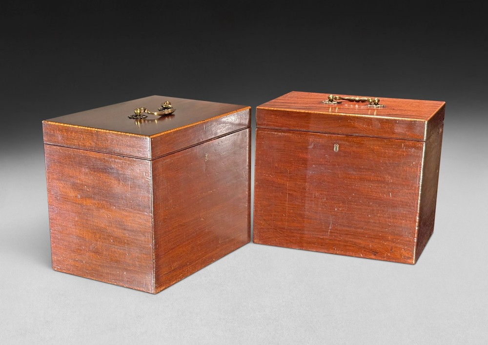 An open George III mahogany decanter chest displaying fitted glass decanters, internal compartments, velvet lid lining, and brass hardware. View IV