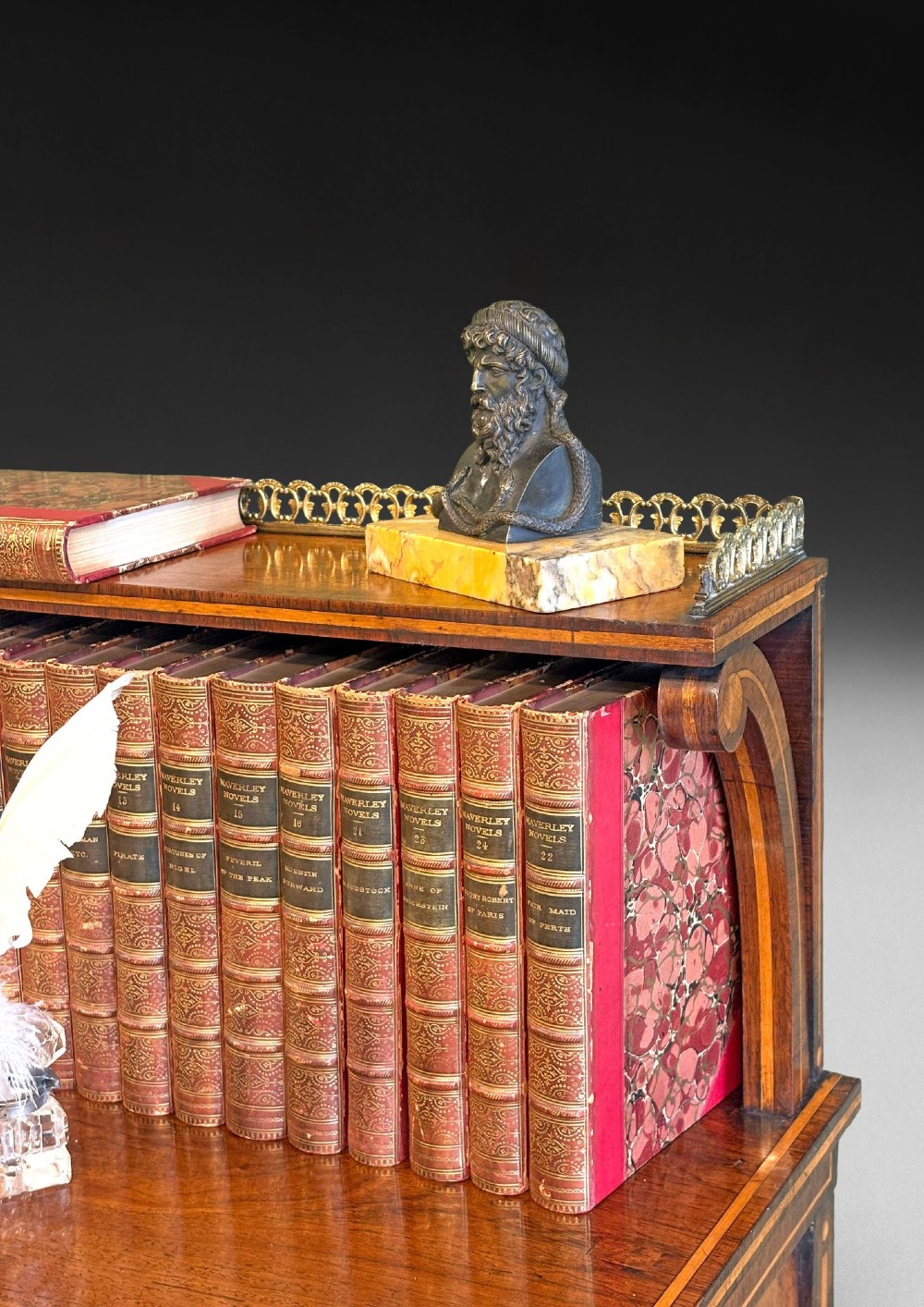 A pair of Regency rosewood chiffoniers featuring boxwood stringing, brass lattice panel doors, upper display shelves with brass galleries, and claw feet. View V