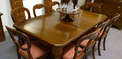 An Eight Seat Walnut Extending Dining Table with Two Leaves