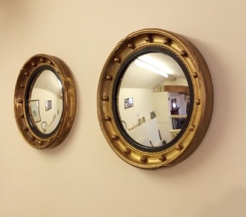 fig 1. A near pair of Gilt convex mirrors from early 1900s in a Regency style.