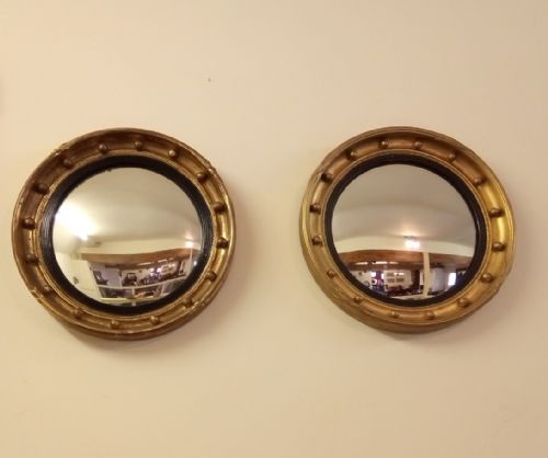 A Near Pair of Gilt Convex Mirrors from Early 1900s in a Regency Style.