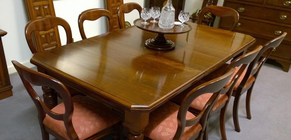 An Eight seat walnut extending dining table with two leaves