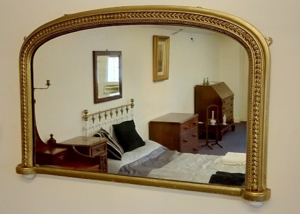 Gilt 19th Century arch top overmantle mirror, landscape.