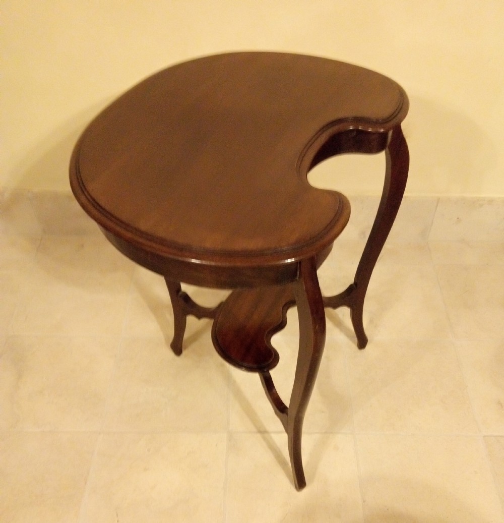 An Edwardian mahogany kidney-shaped occasional table featuring cabriole legs and a matching lower tier shelf. View II