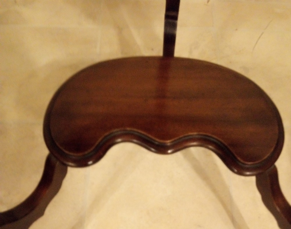 An Edwardian mahogany kidney-shaped occasional table featuring cabriole legs and a matching lower tier shelf. View IV