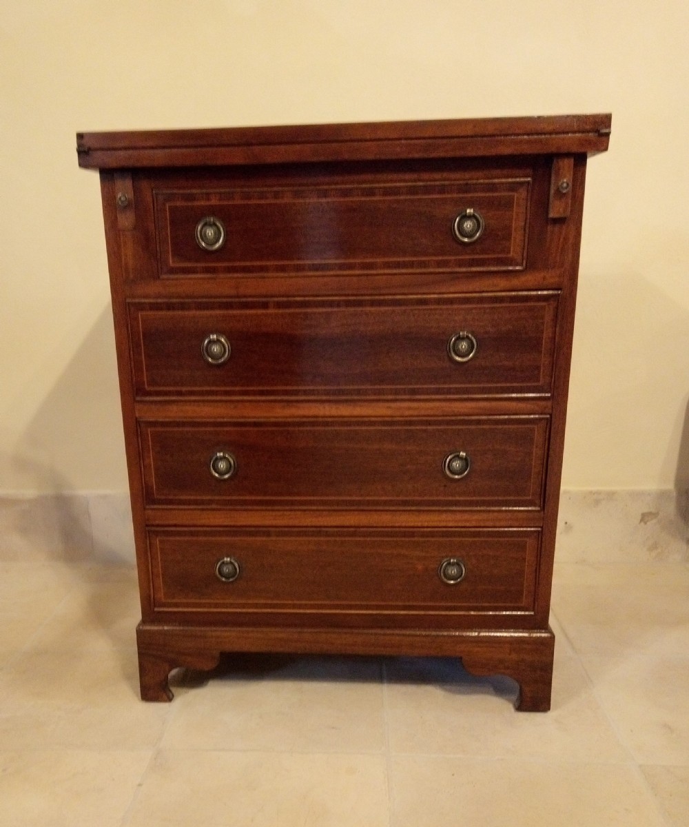 Lovely neat small chest of drawers converts to a desk.