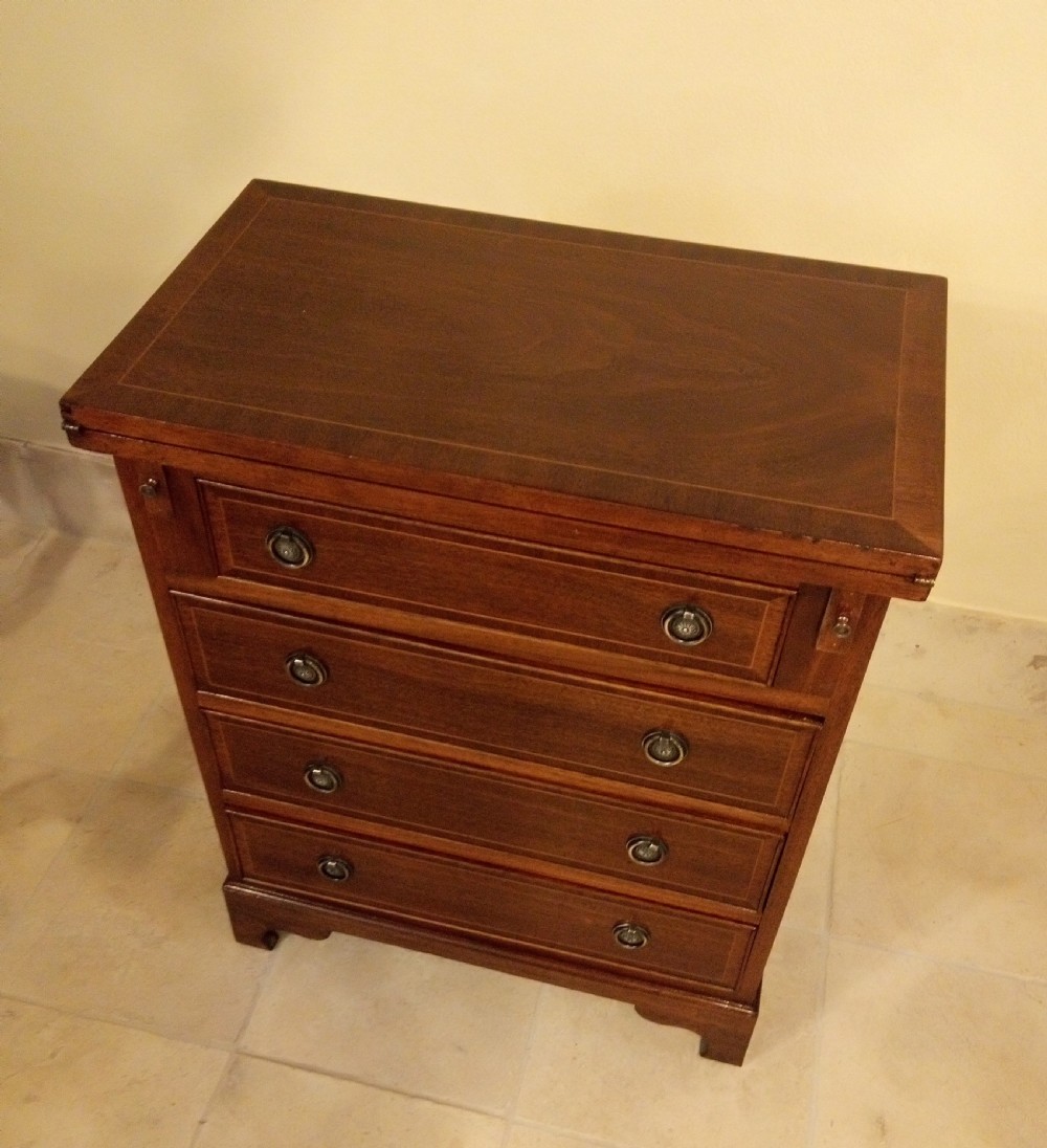 Lovely neat small chest of drawers converts to a desk. View V