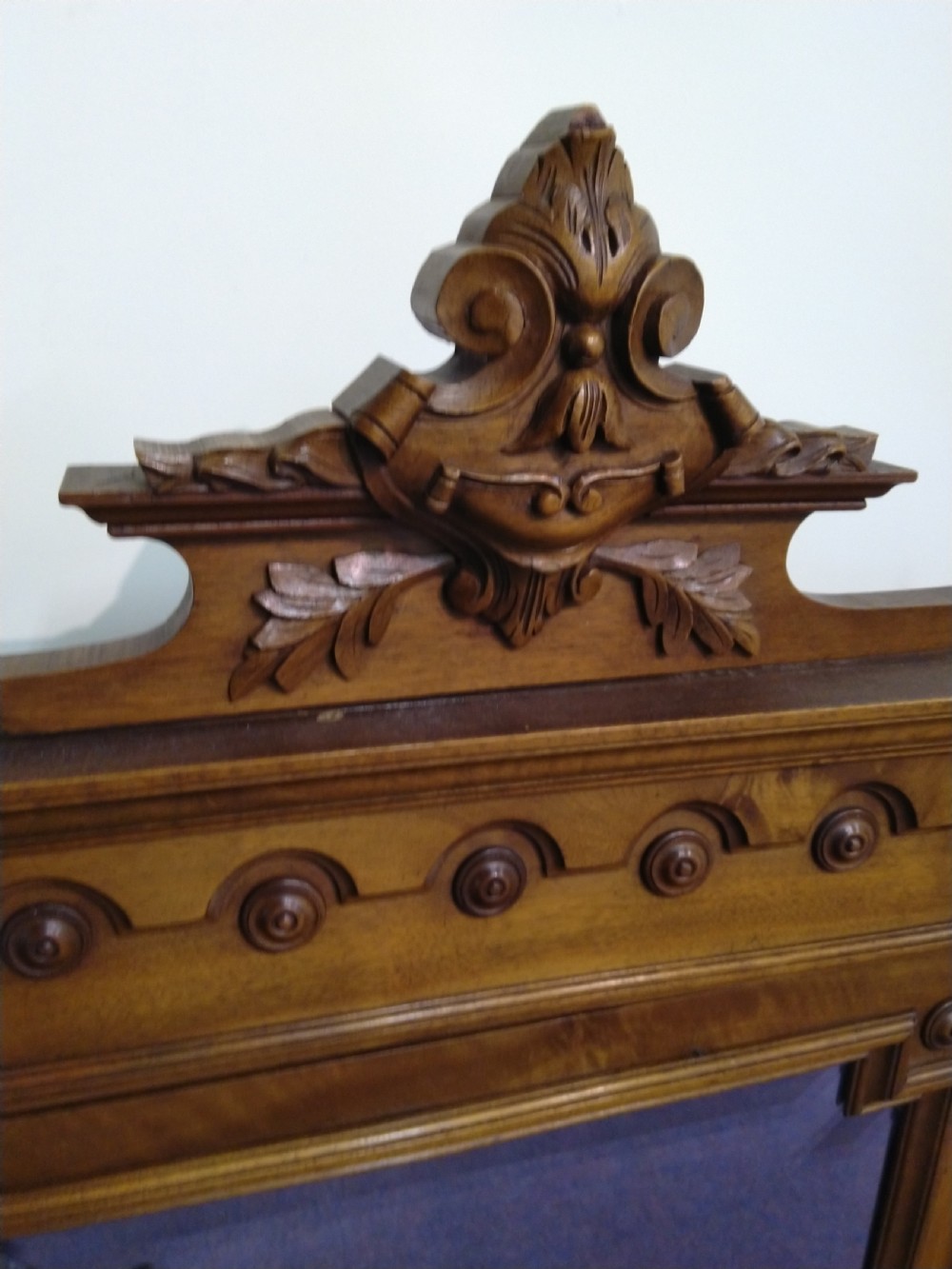 A carved French walnut dressing table mirror featuring an ornate carved pediment, fluted side columns, rectangular mirror glass, and two small trinket drawers at the base. View IV