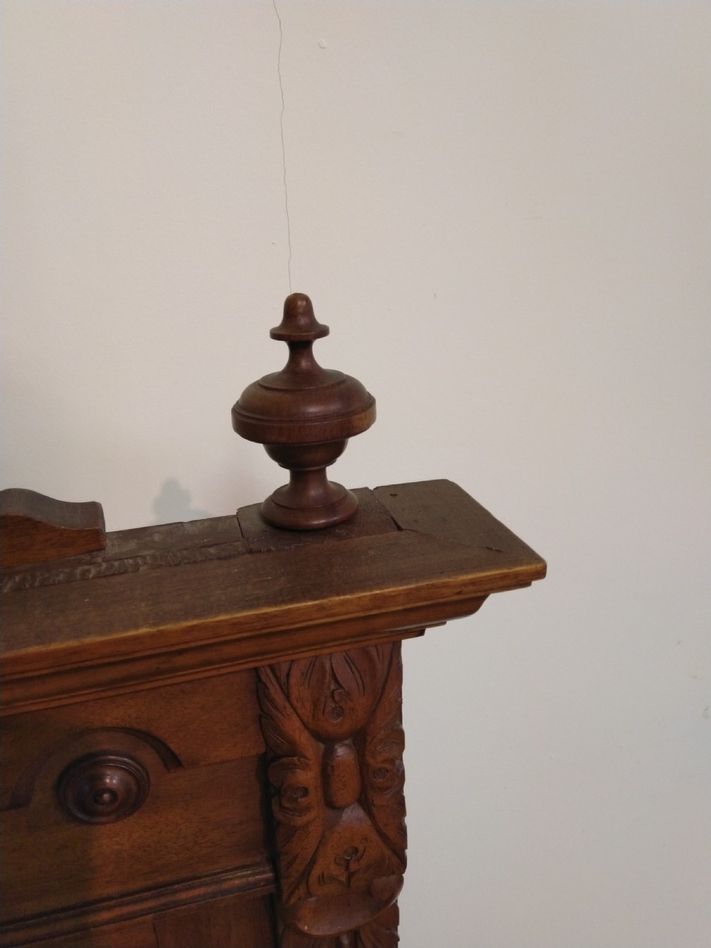 A carved French walnut dressing table mirror featuring an ornate carved pediment, fluted side columns, rectangular mirror glass, and two small trinket drawers at the base. View V