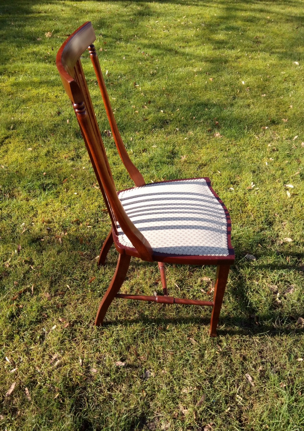 An Edwardian mahogany side chair featuring vertical back splats with fine string inlay and a cream upholstered drop-in seat. View III