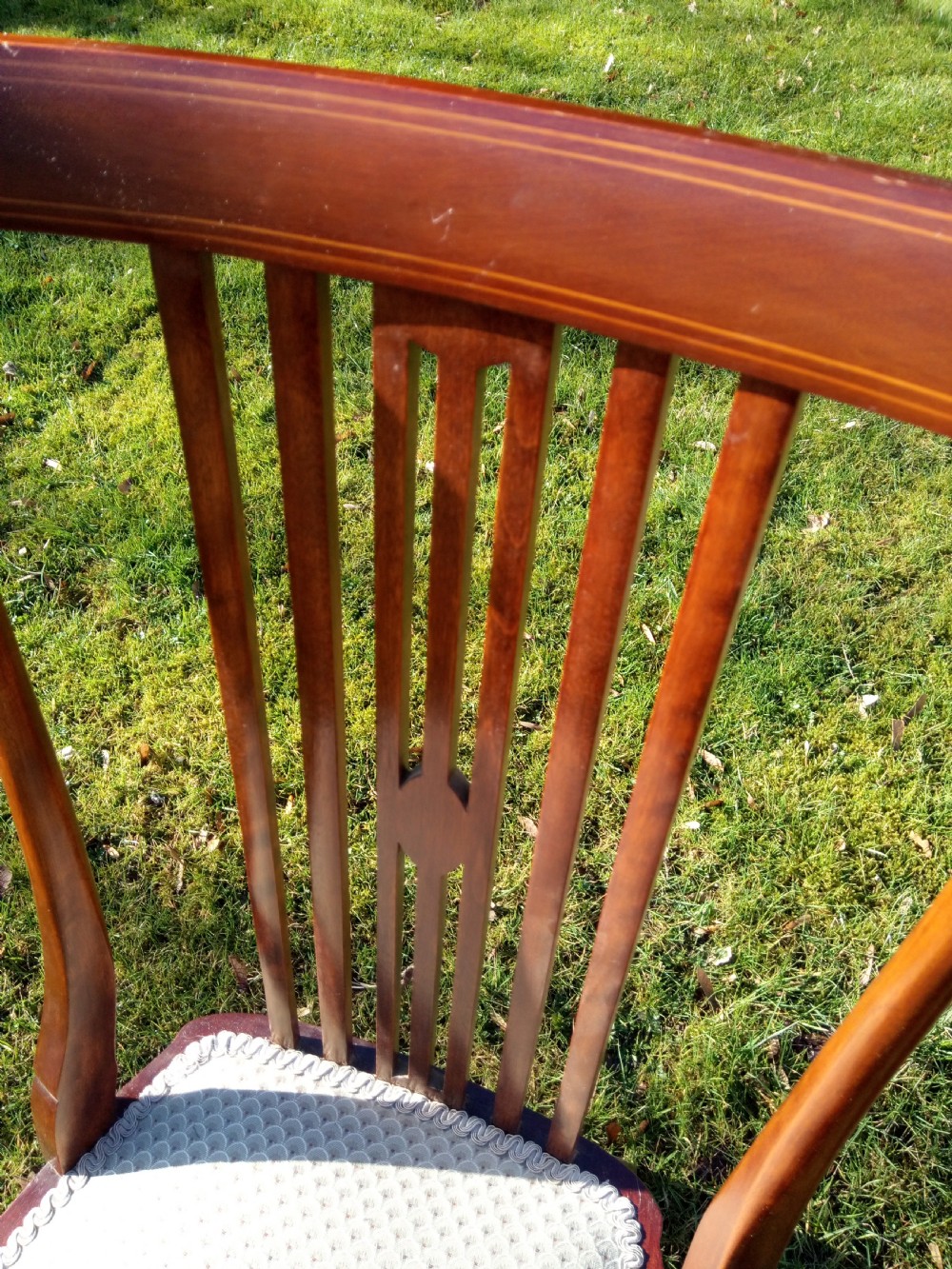 An Edwardian mahogany side chair featuring vertical back splats with fine string inlay and a cream upholstered drop-in seat. View V