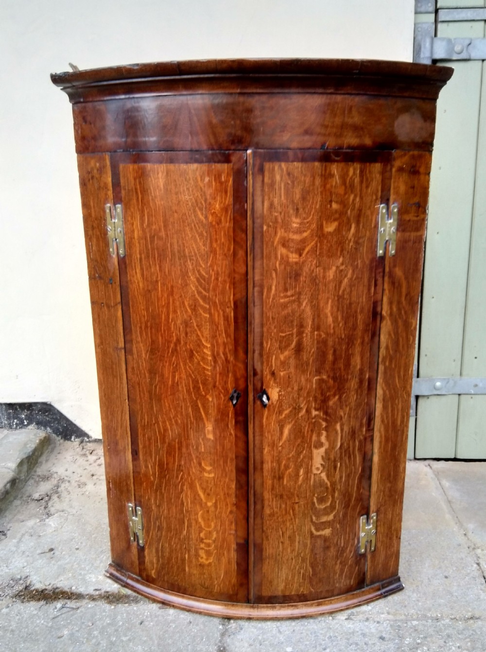 Bow front corner cabinet in Oak