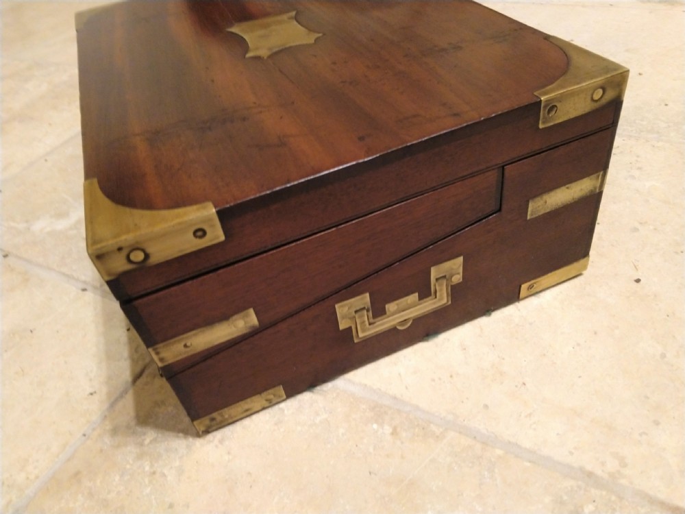 A rectangular dark mahogany wood writing slope featuring polished brass corner mounts, an escutcheon, and a brass central cartouche. View III