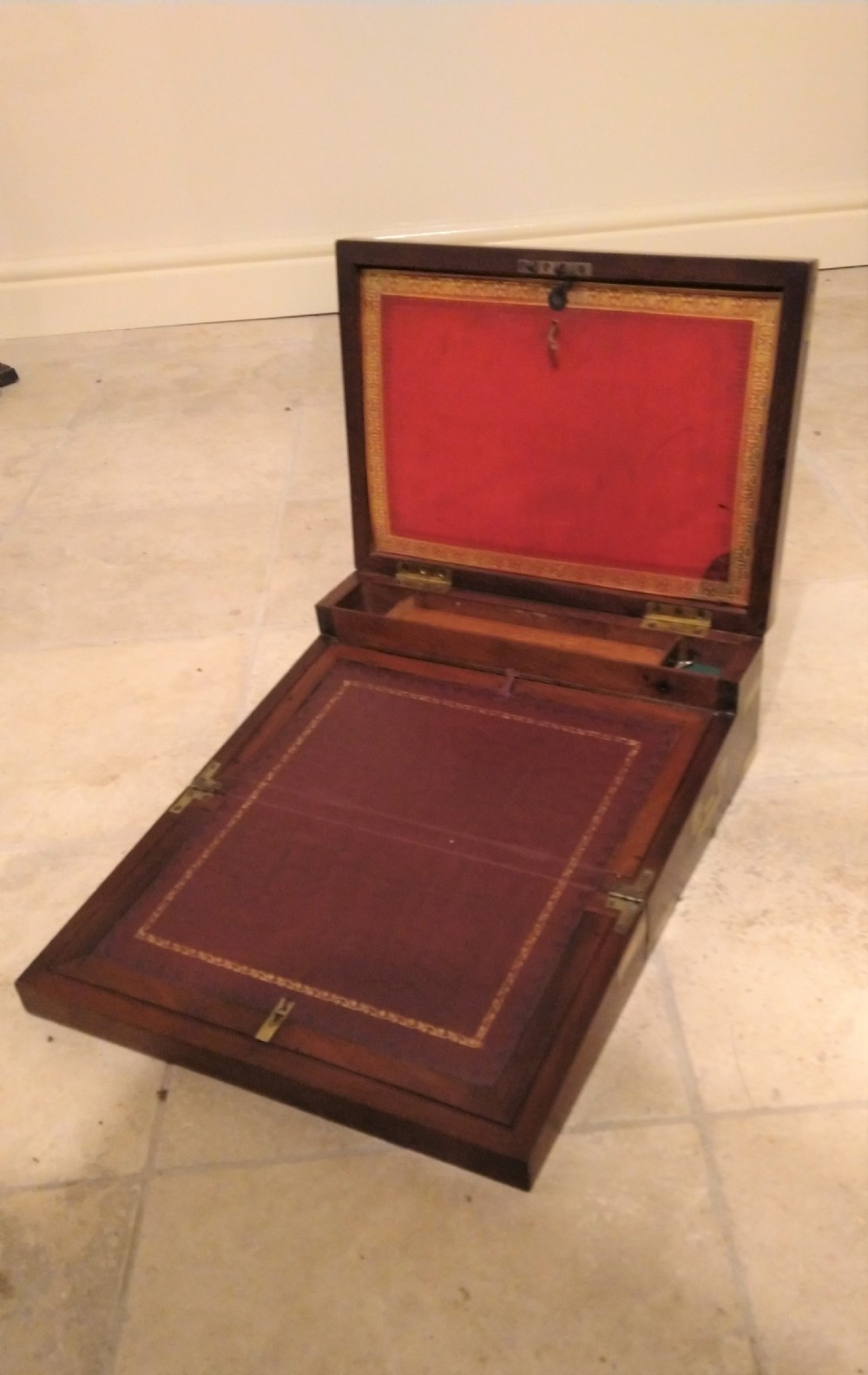 A rectangular dark mahogany wood writing slope featuring polished brass corner mounts, an escutcheon, and a brass central cartouche. View IX
