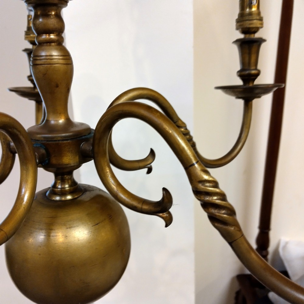 A five-arm solid brass ceiling chandelier featuring scrolled arms, bulb holders, and a central column with a spherical base suspended from a chain. View III