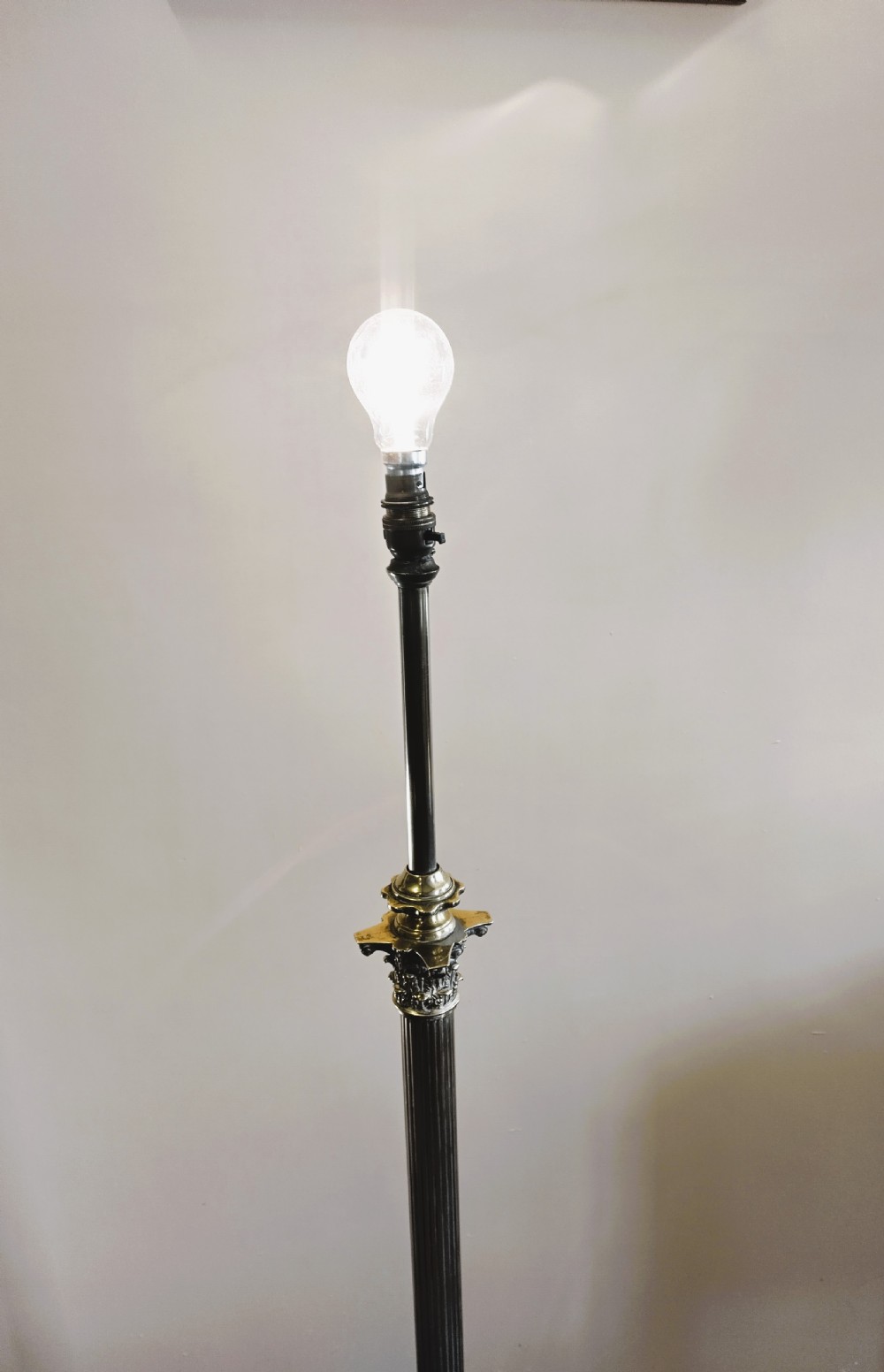 A solid brass Neoclassical standard lamp featuring a fluted column shaft, stepped square base on paw feet, and a tall cream fabric shade. View VII