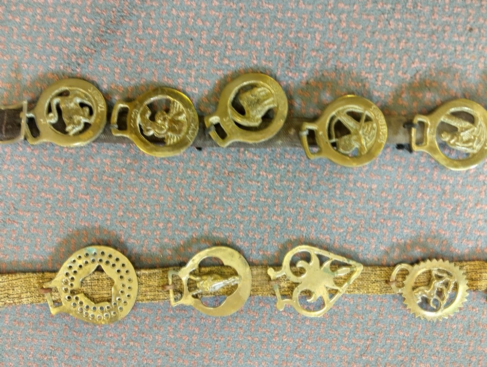 Two vertical leather martingale straps mounted with twenty-two brass horse brasses, including a complete set featuring astrological Zodiac symbols. View II